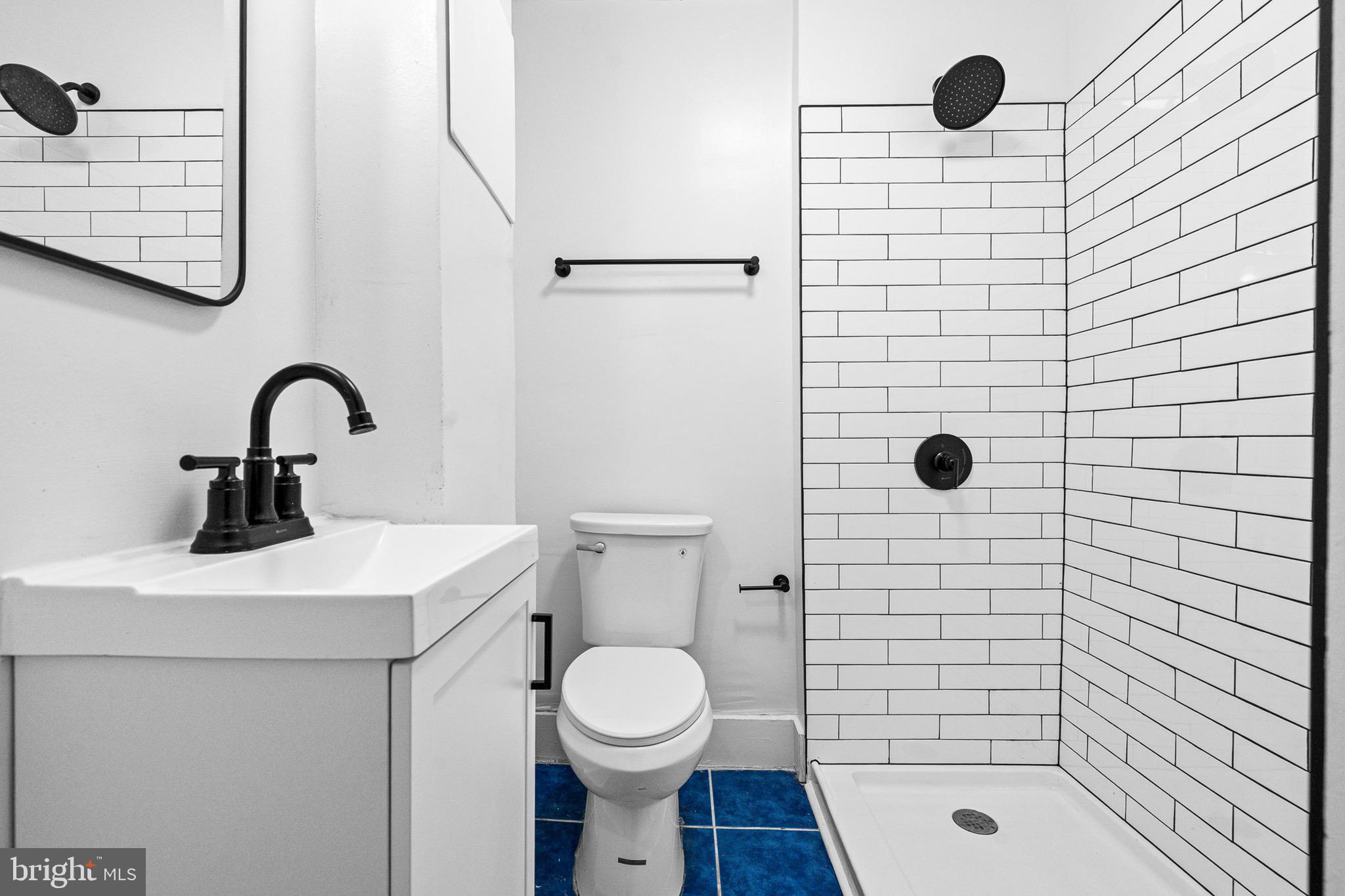 1308 West Lexington Street, Unit 2R Baltimore, MD 21223 - Photo 6 of 12 a bathroom with a sink a toilet and shower