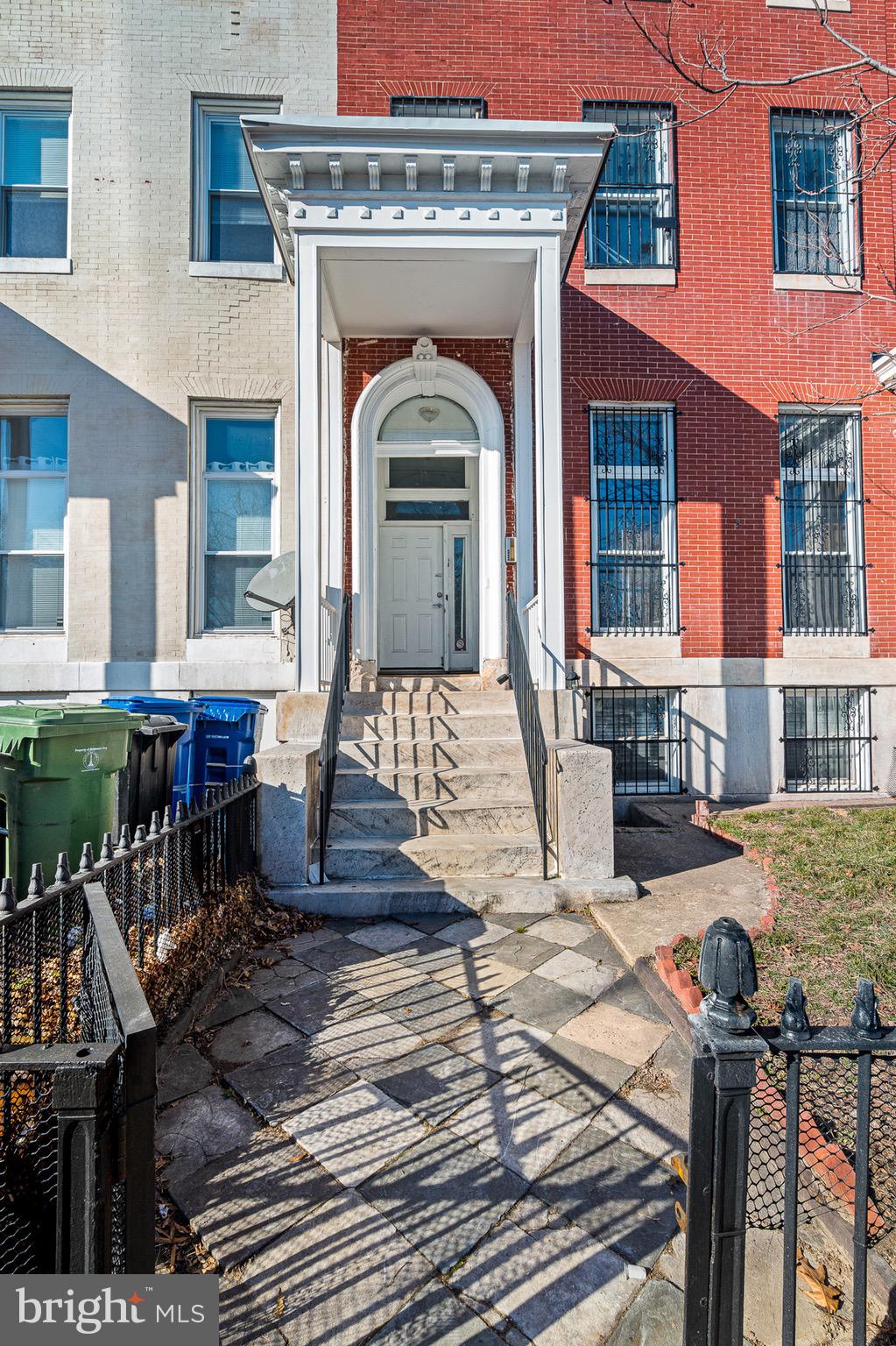 1308 West Lexington Street, Unit 2R Baltimore, MD 21223 - Photo 10 of 12 a front view of a building with many windows