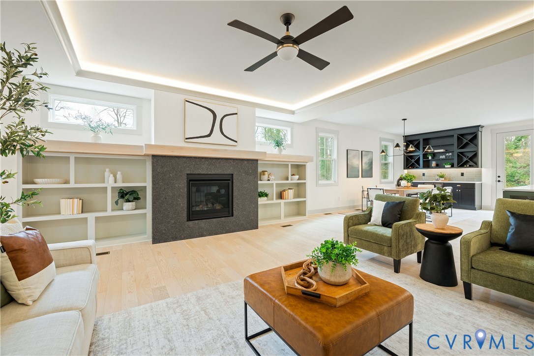 8919 Rustic Road Richmond, VA 23235 - Photo 8 of 36 Spacious living area featuring a dark stone-clad f
