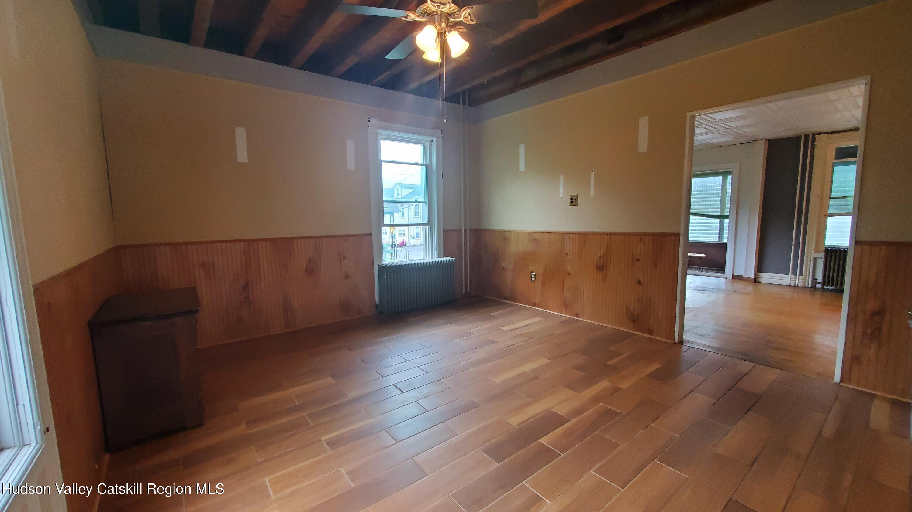 102 2nd Street Athens, NY 12015 - Photo 12 of 19 a view of an empty room with wooden floor and a window