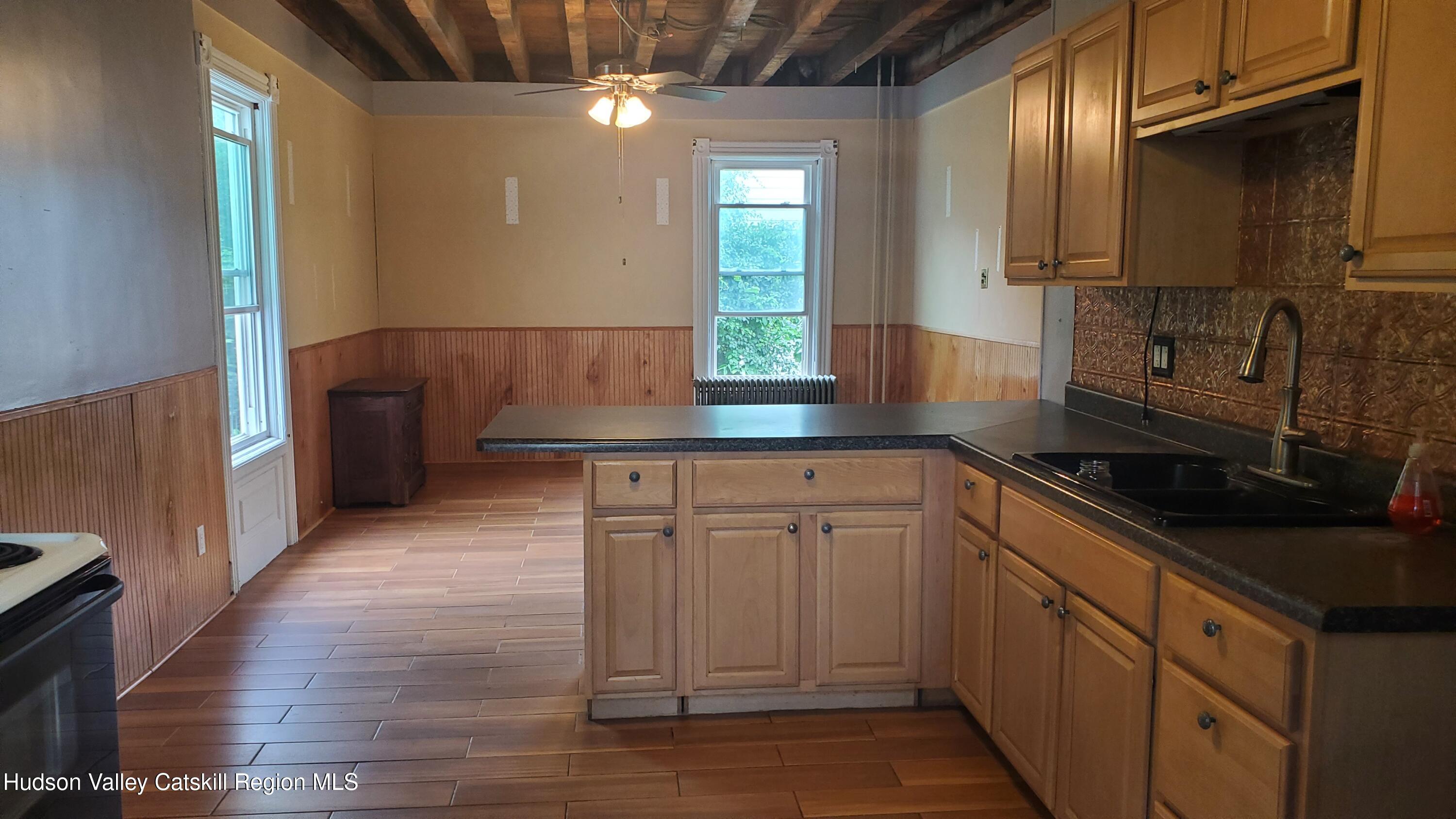 102 2nd Street Athens, NY 12015 - Photo 13 of 19 a kitchen with granite countertop a sink stainless steel appliances and cabinets