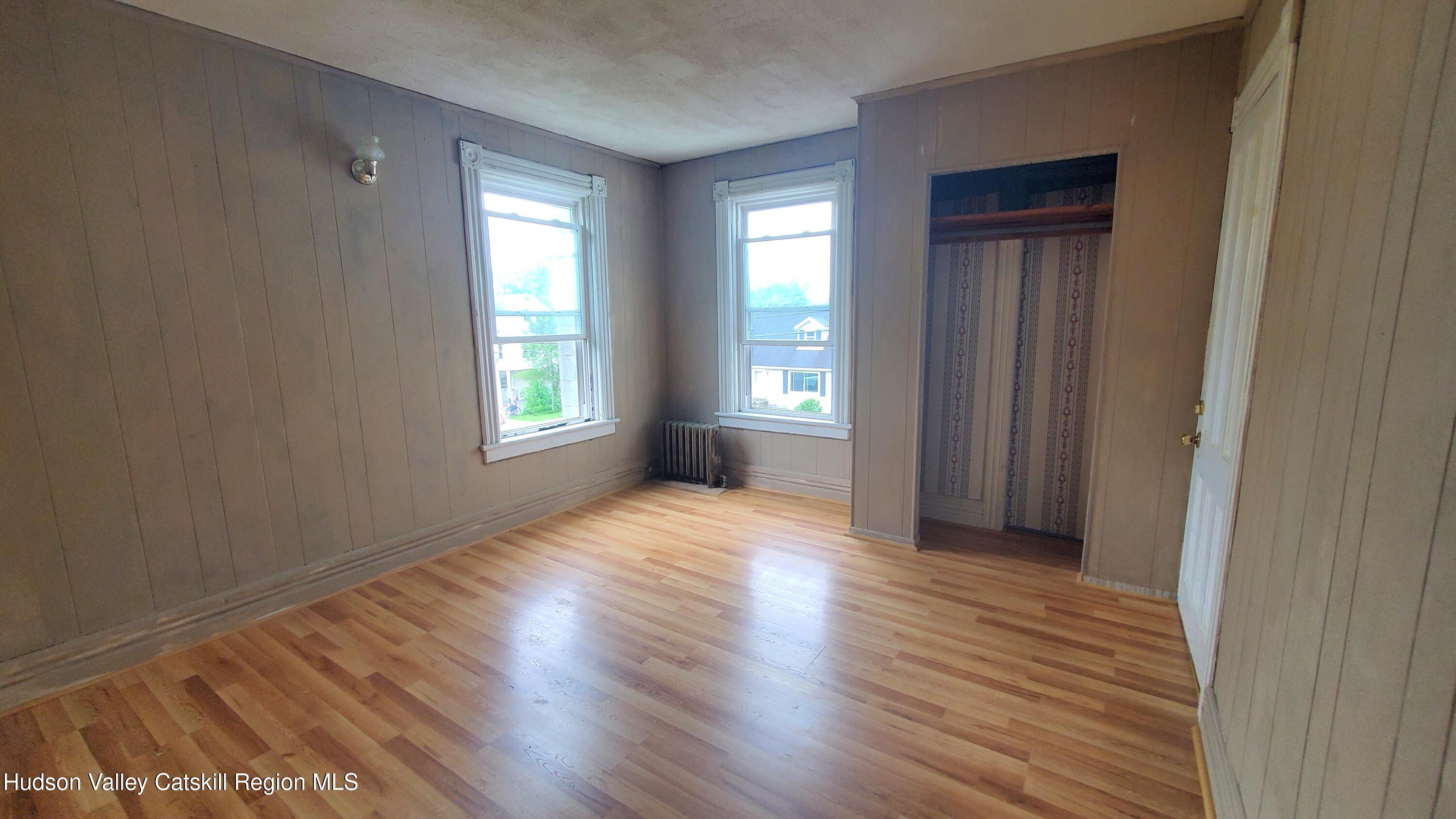 102 2nd Street Athens, NY 12015 - Photo 17 of 19 a view of an empty room with wooden floor and a window