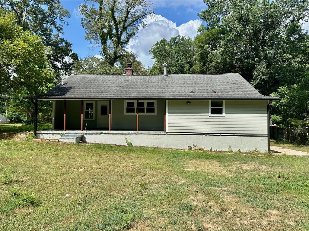 6538 North Sweetwater Road Lithia Springs, GA 30122 - Photo 12 of 16 a view of a house with a large pool and a large tree
