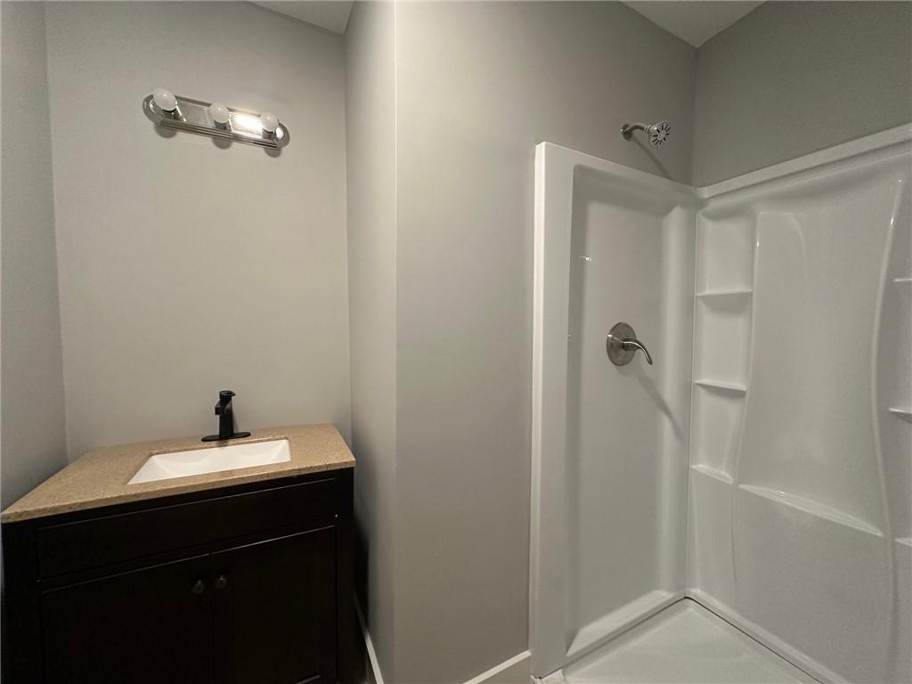 6538 North Sweetwater Road Lithia Springs, GA 30122 - Photo 6 of 16 a bathroom with a sink a mirror and a shower