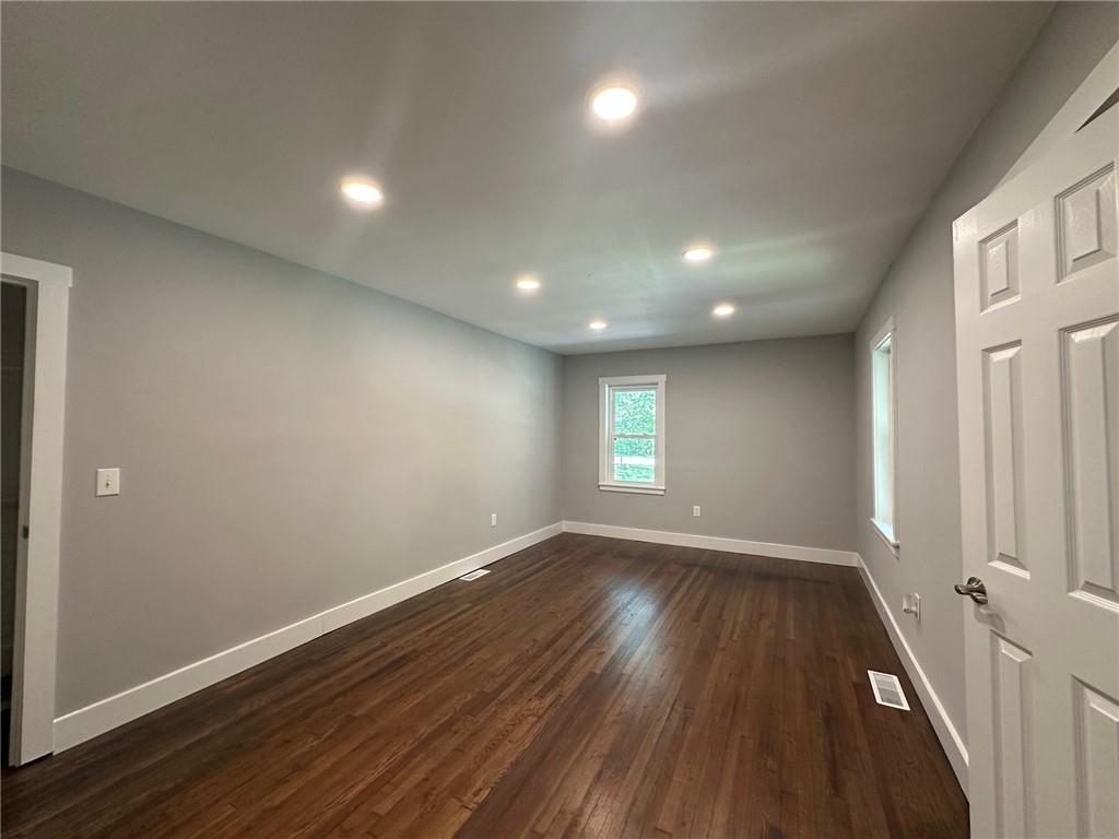 6538 North Sweetwater Road Lithia Springs, GA 30122 - Photo 8 of 16 an empty room with wooden floor and windows