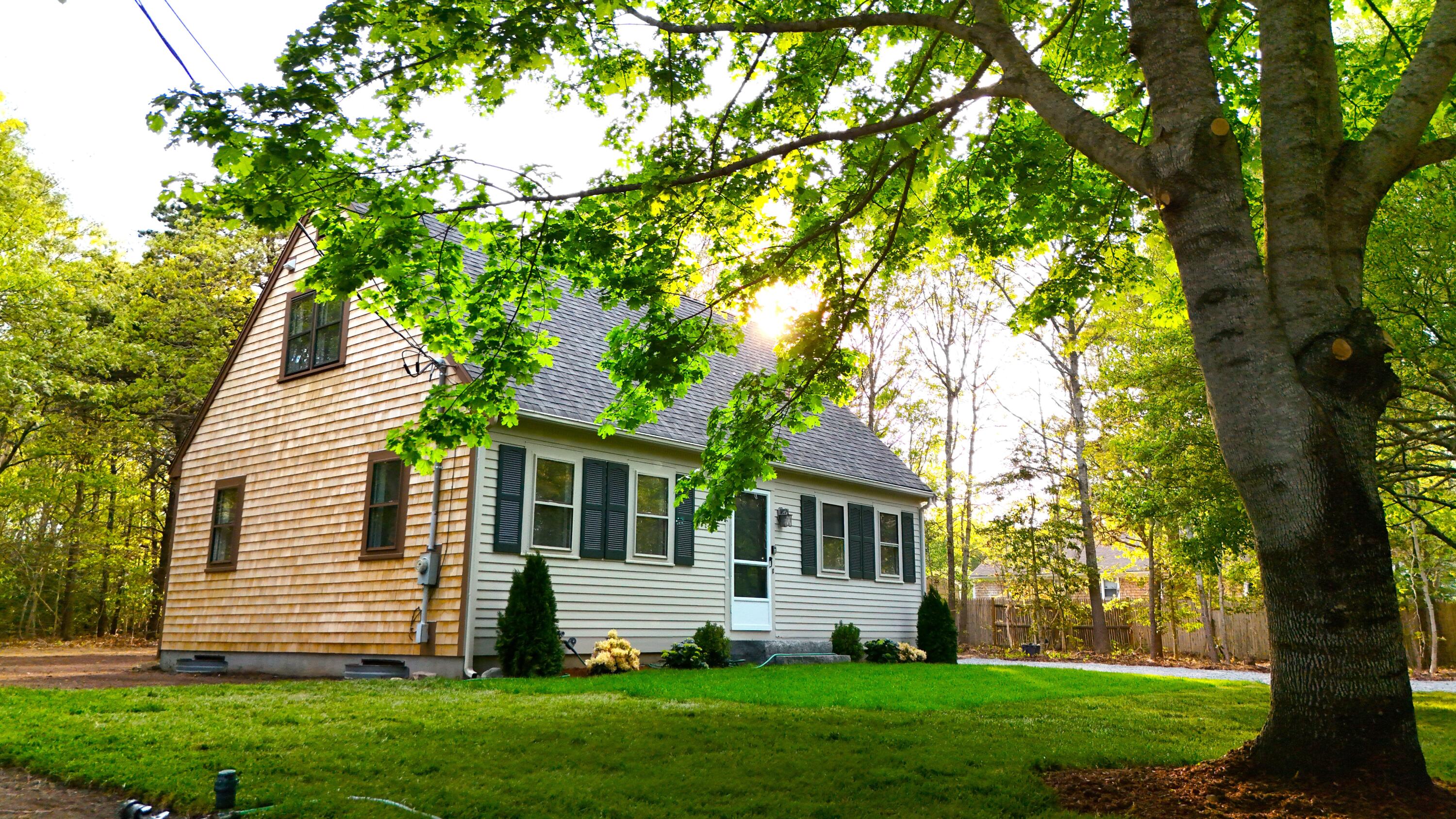 147 Chippingstone Road Marstons Mills, MA 02648 - Photo 1 of 23 a front view of a house with a garden