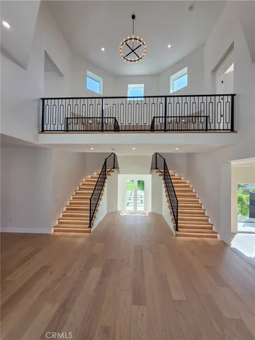 a large white kitchen with a large island oven a stove and a sink