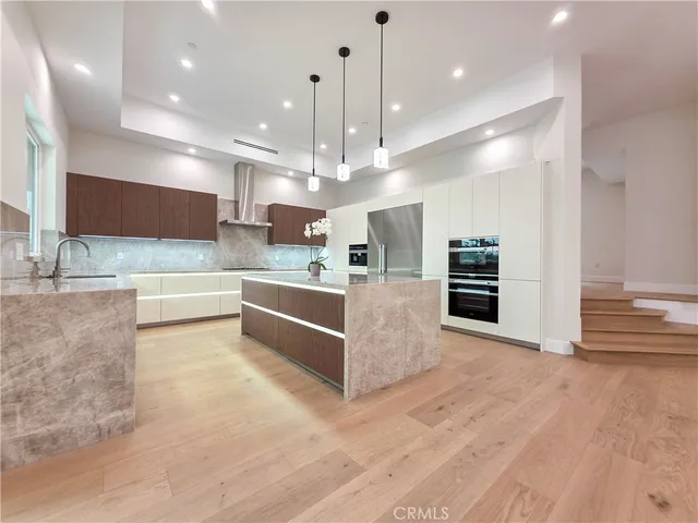 a large white kitchen with a large window