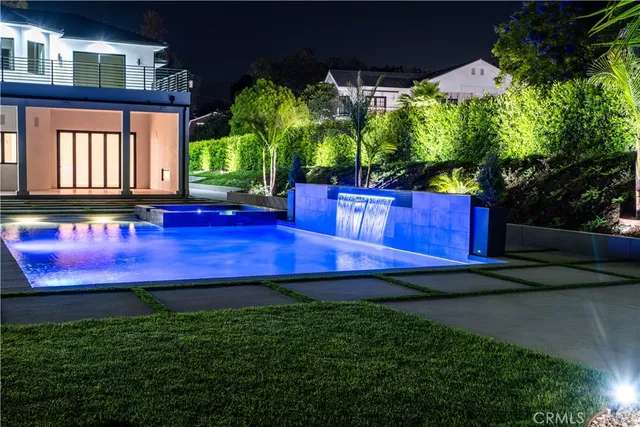 a view of swimming pool is middle in a yard