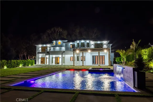 a front view of a house with a yard table and chairs