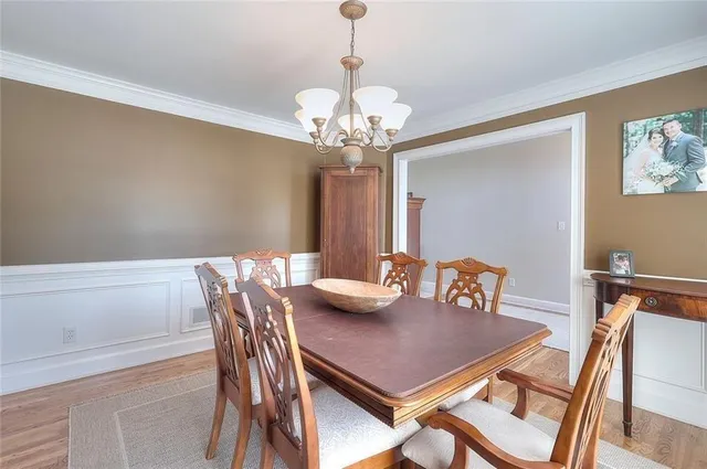 a view of a dining room with furniture and chandelier