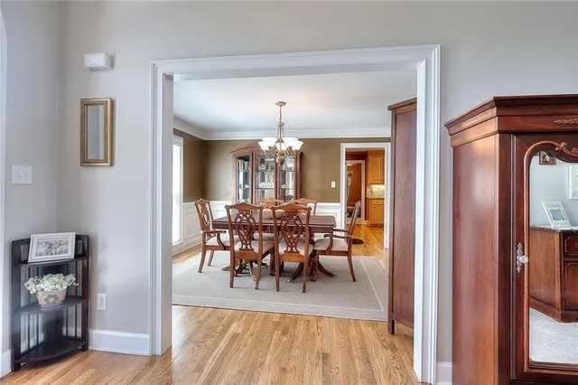 a view of a dining room with furniture and a chandelier