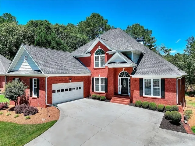 a front view of a house with garden