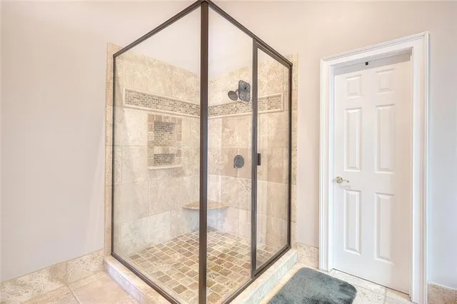 a bathroom with a glass shower door