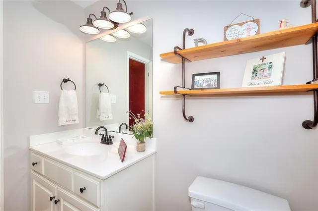 a bathroom with a sink a mirror and a toilet