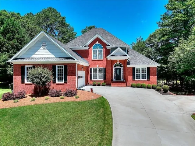 a front view of a house with a yard and porch