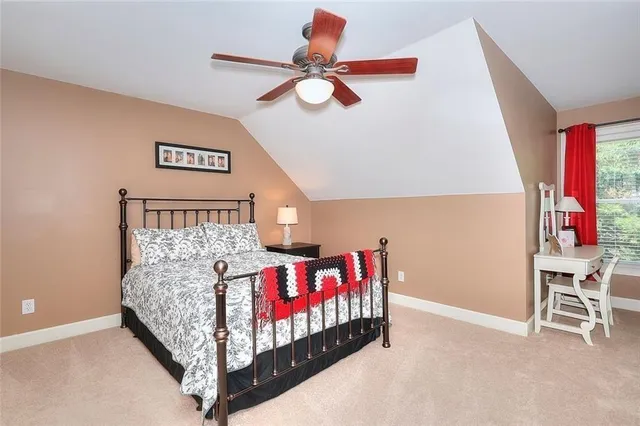 a bedroom with a bed and a flat tv screen on dresser