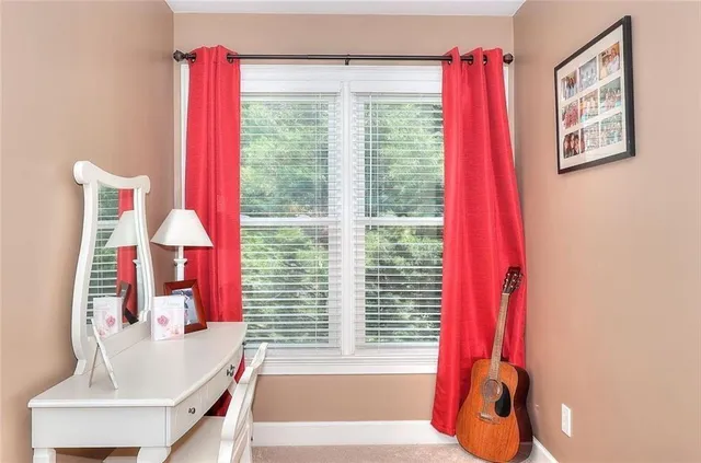 a bedroom with a large bed and a window