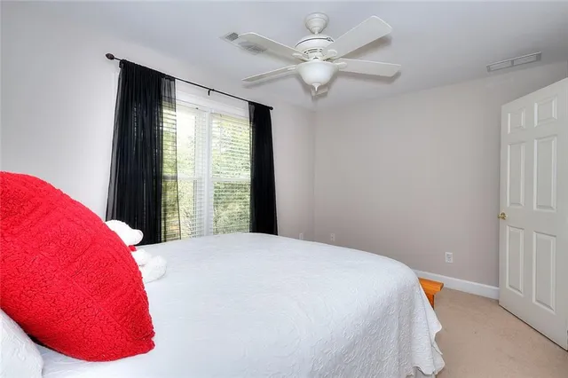 a bedroom with a bed and a large window