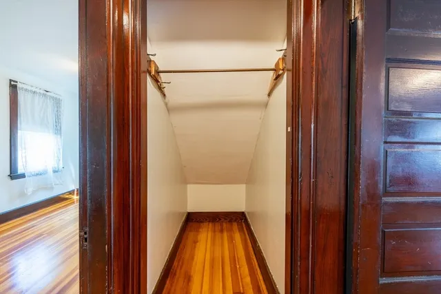 a view of room with window and wooden floor
