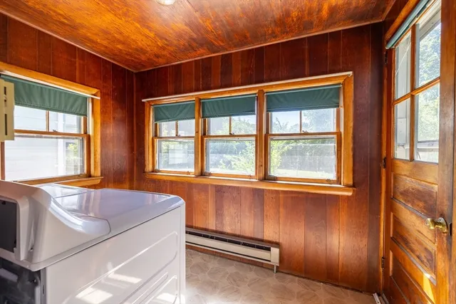 a view of a hallway with furniture and windows