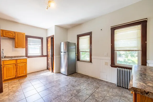 a view of empty room with a fireplace and windows