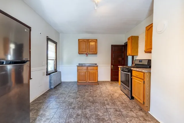 a view of a room with wooden floor and cabinet