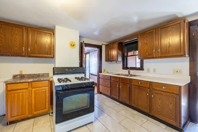 a kitchen with granite countertop cabinets stainless steel appliances and wooden cabinets