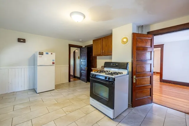 a kitchen with a stove top oven and refrigerator