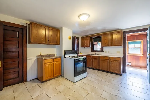 a kitchen with stainless steel appliances granite countertop a stove top oven sink and cabinets
