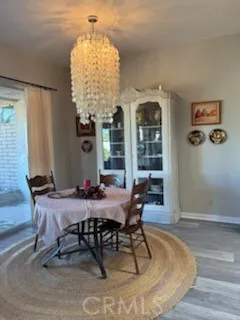 a view of a dining room with furniture and chandelier