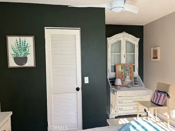 a bedroom with a bed and a mirror