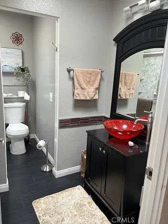a bathroom with a toilet and a mirror