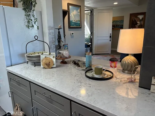 a kitchen with a sink and a stove with wooden floor