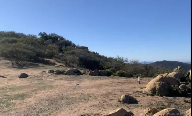 a view of a yard with a snow in the background