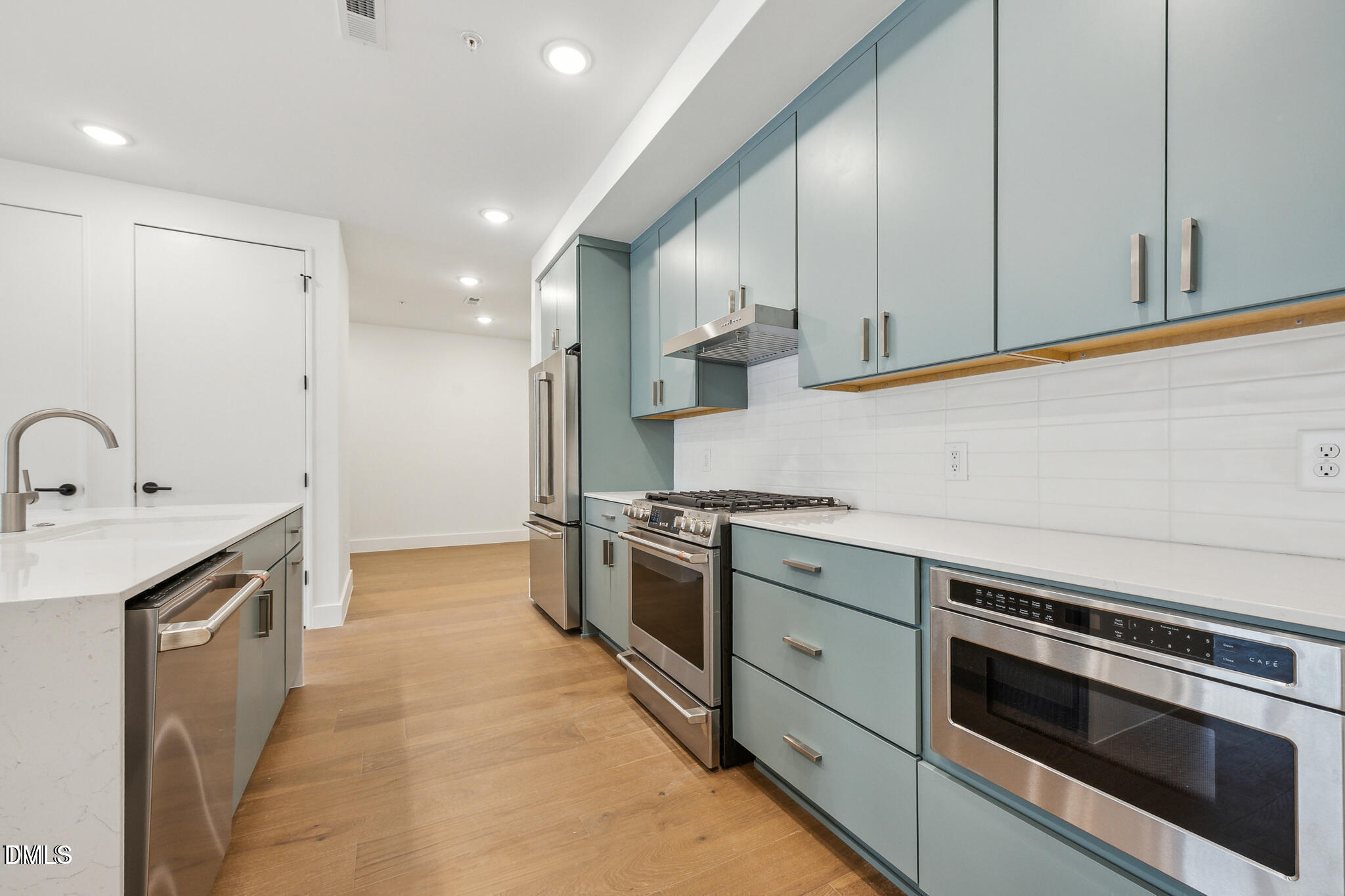 29 Enterprise Street, Unit 109 Raleigh, NC 27607 - Photo 6 of 18 a kitchen with stainless steel appliances granite countertop a sink a stove and a refrigerator