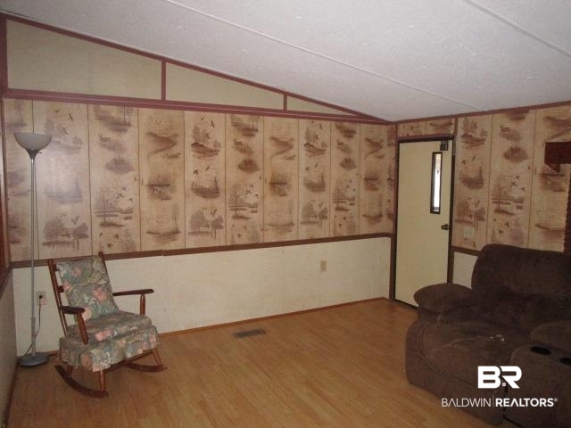 20705 Greek Cemetery Road Robertsdale, AL 36567 - Photo 10 of 25 Sitting room featuring wood finished floors and vaulted ceiling
