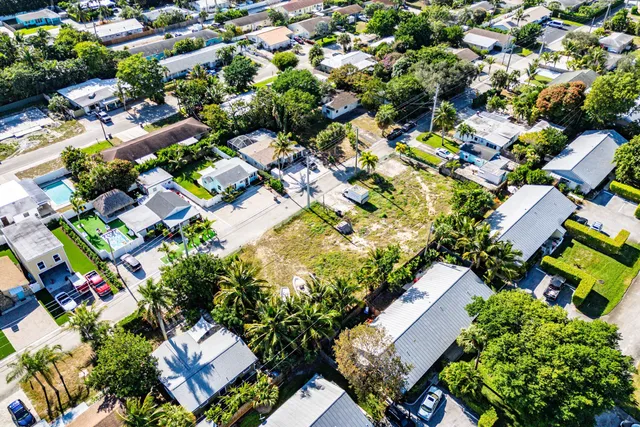 an aerial view of residential house with outdoor space and trees all around