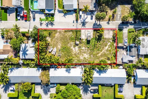 an aerial view of residential houses with outdoor space and swimming pool
