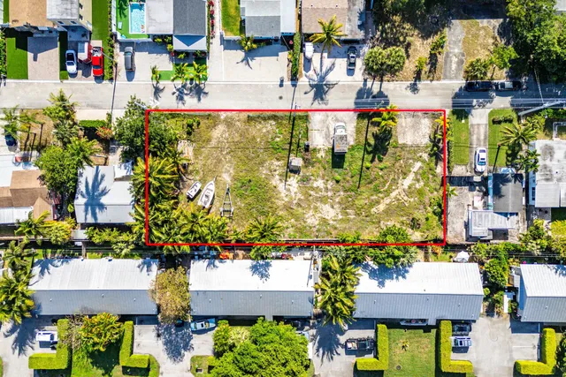 an aerial view of residential houses with outdoor space and swimming pool