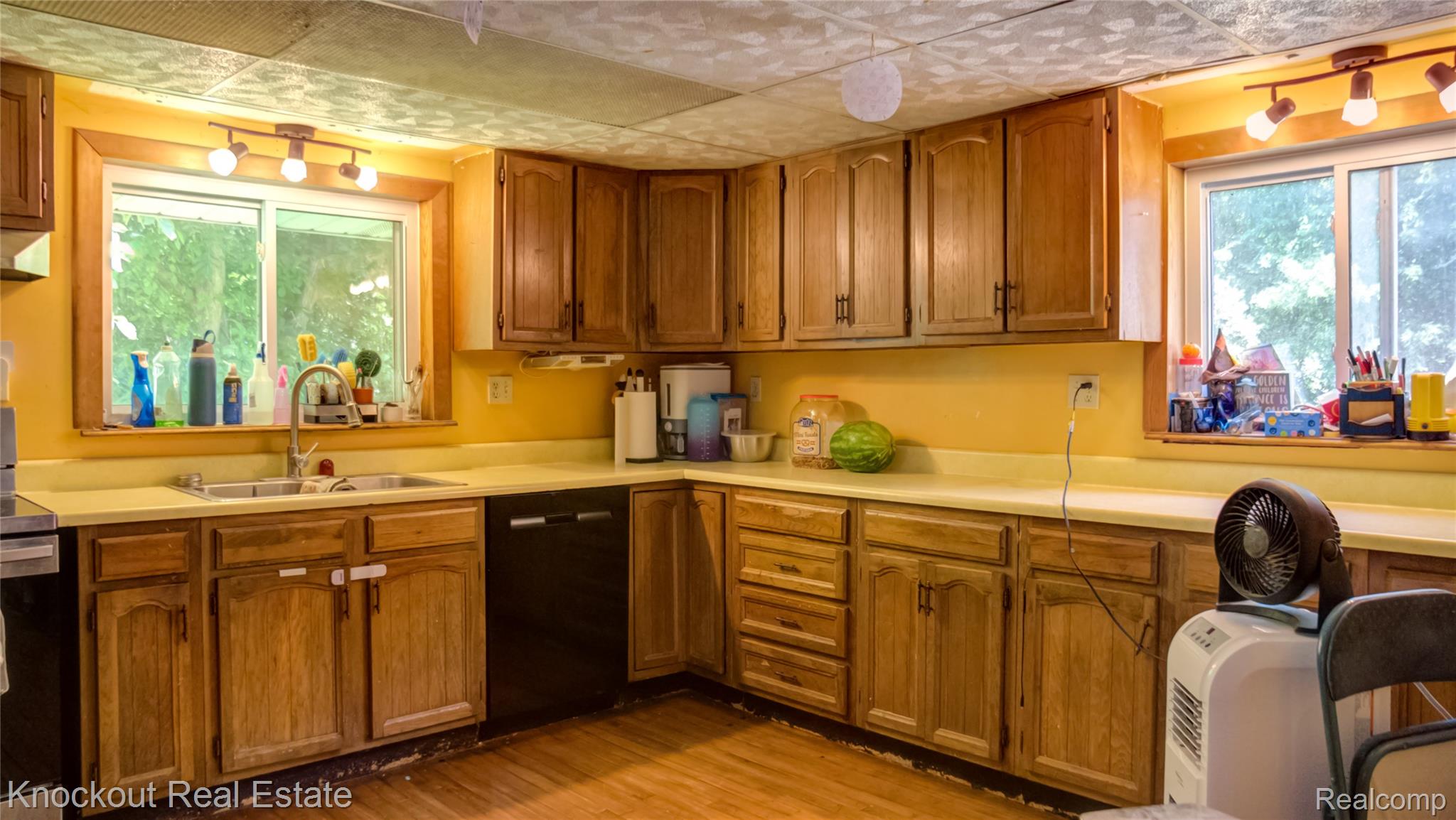 4195 Williamson Road Saginaw, MI 48601 - Photo 16 of 50 Kitchen featuring wood cabinetry, light countertops, and a double basin sink with a gooseneck faucet