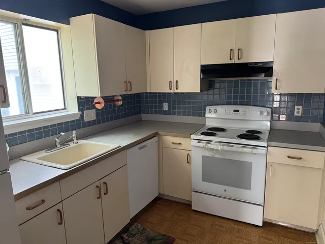 a kitchen with a sink stove and cabinets