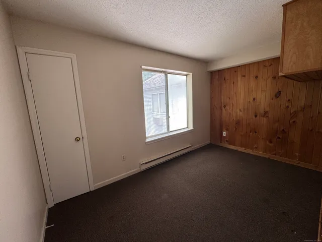 a view of a livingroom with an empty space and a window