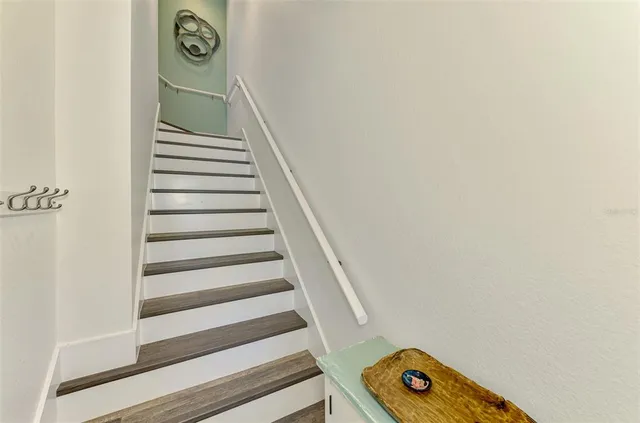 a kitchen with granite countertop stainless steel appliances a sink a stove and cabinets