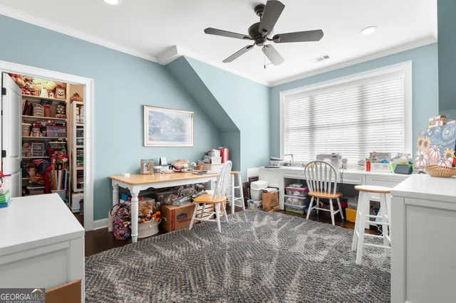 a view of a workspace with furniture and window