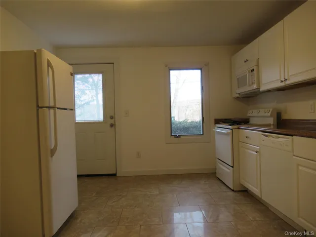 a kitchen with a refrigerator a sink and cabinets