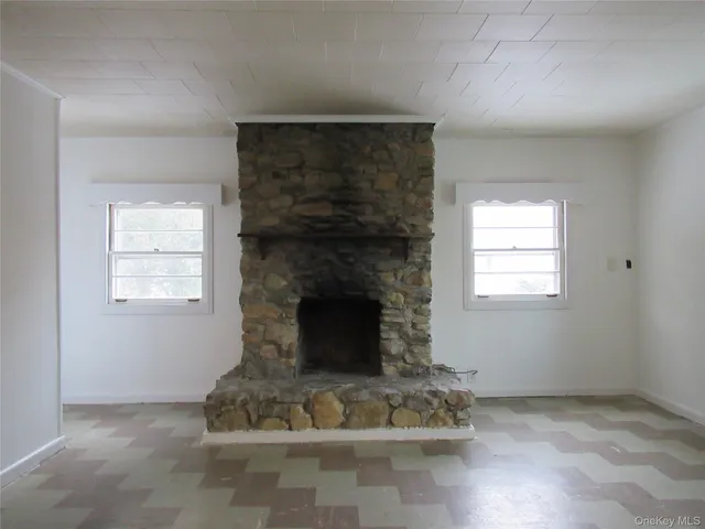 a living room with furniture window and a fireplace