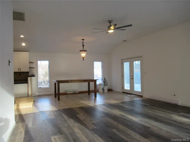 a view of game room with window and wooden floor