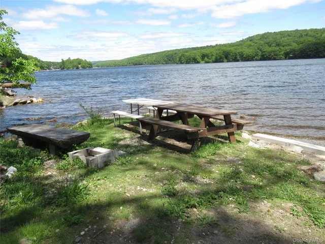 a view of a lake with outdoor seating