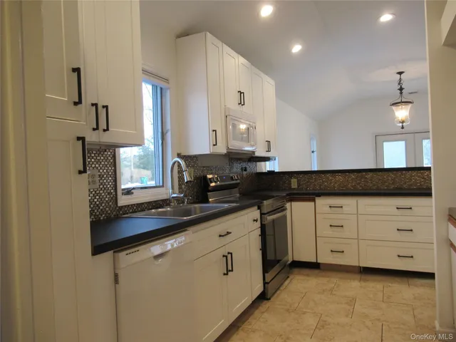a kitchen with cabinets and window